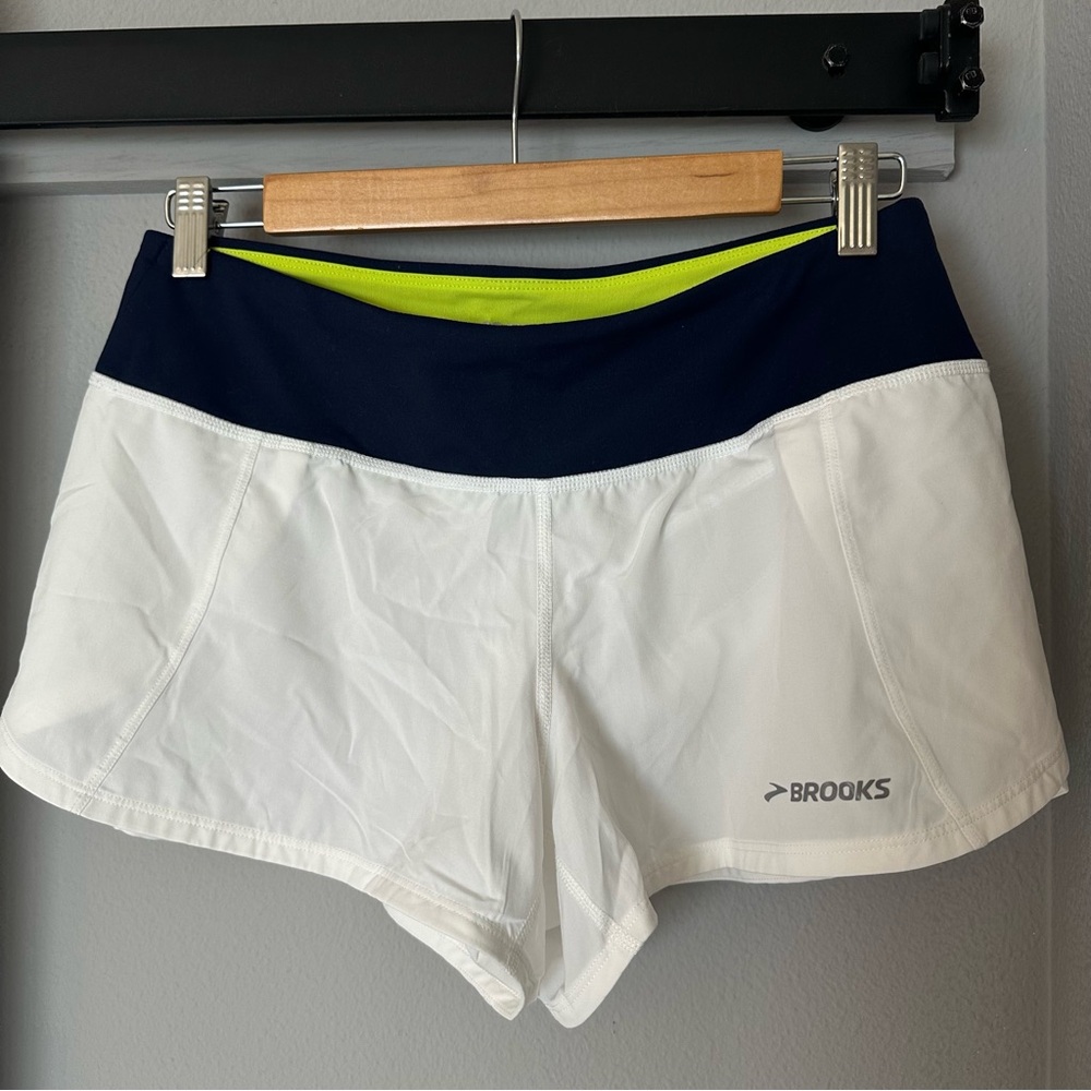 Brooks Women's White and Navy Split Shorts. Bright yellow lining. Built in liner